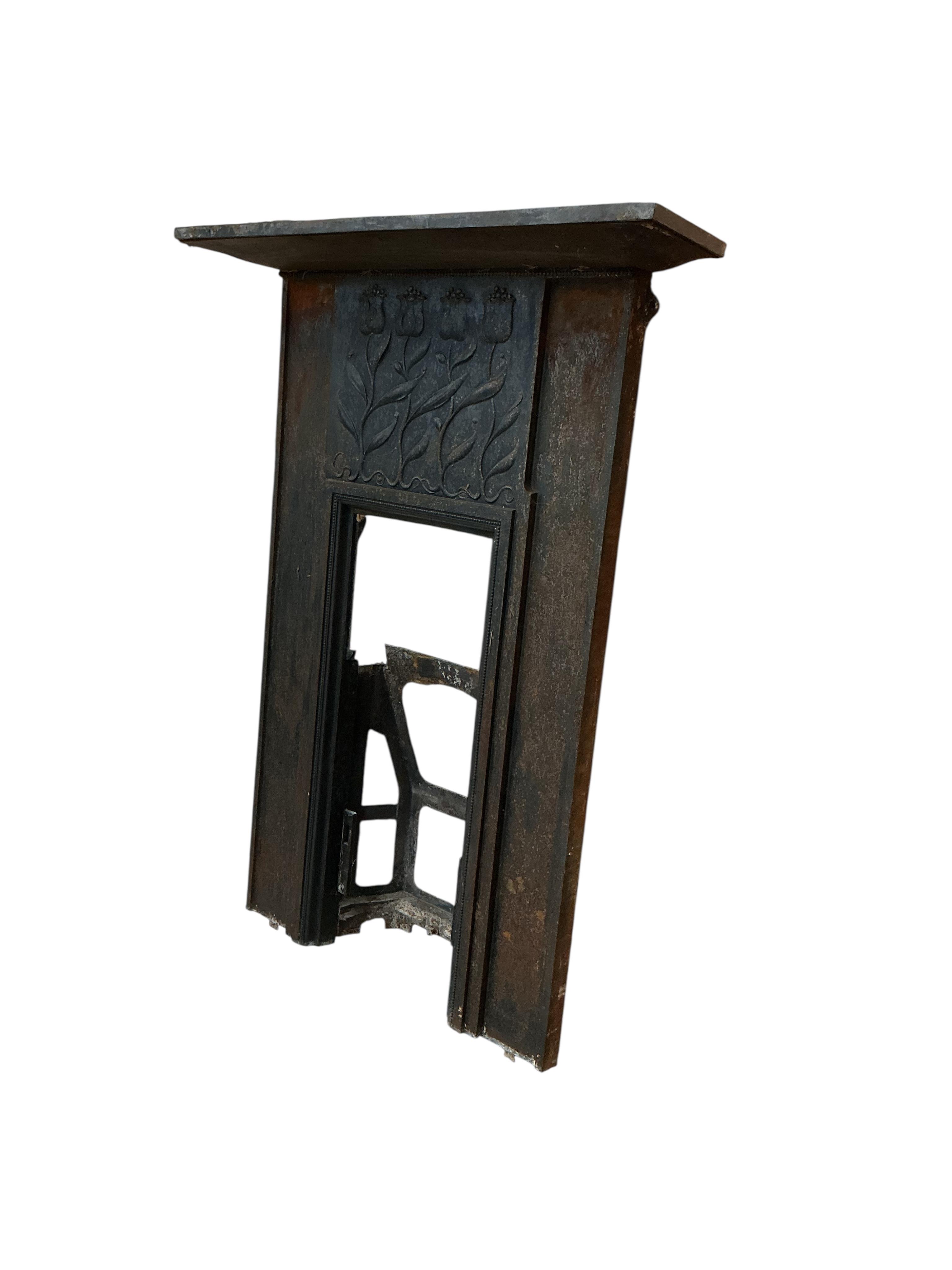 A late Victorian Art Nouveau cast iron fire surround, with tulip design, width 94cm, height 126cm